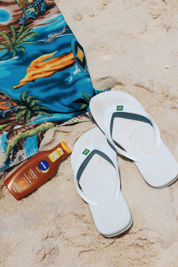 Flip-flops, Towel And A Sunscreen On The Beach 