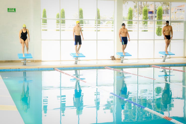 Men And Woman In Training At Swimming Pool