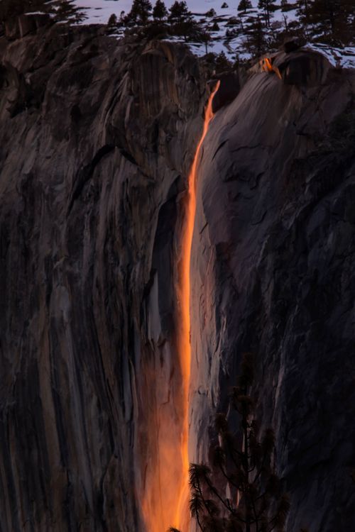 Free Stunning image of Yosemite's Firefall, showcasing glowing water against rugged cliffs at sunset. Stock Photo
