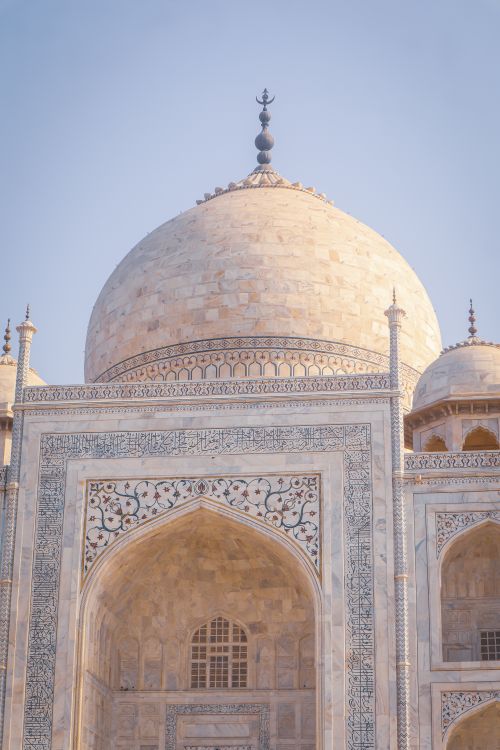 Free Close-up of the Taj Mahal's dome, showcasing intricate marble details at sunrise. Stock Photo