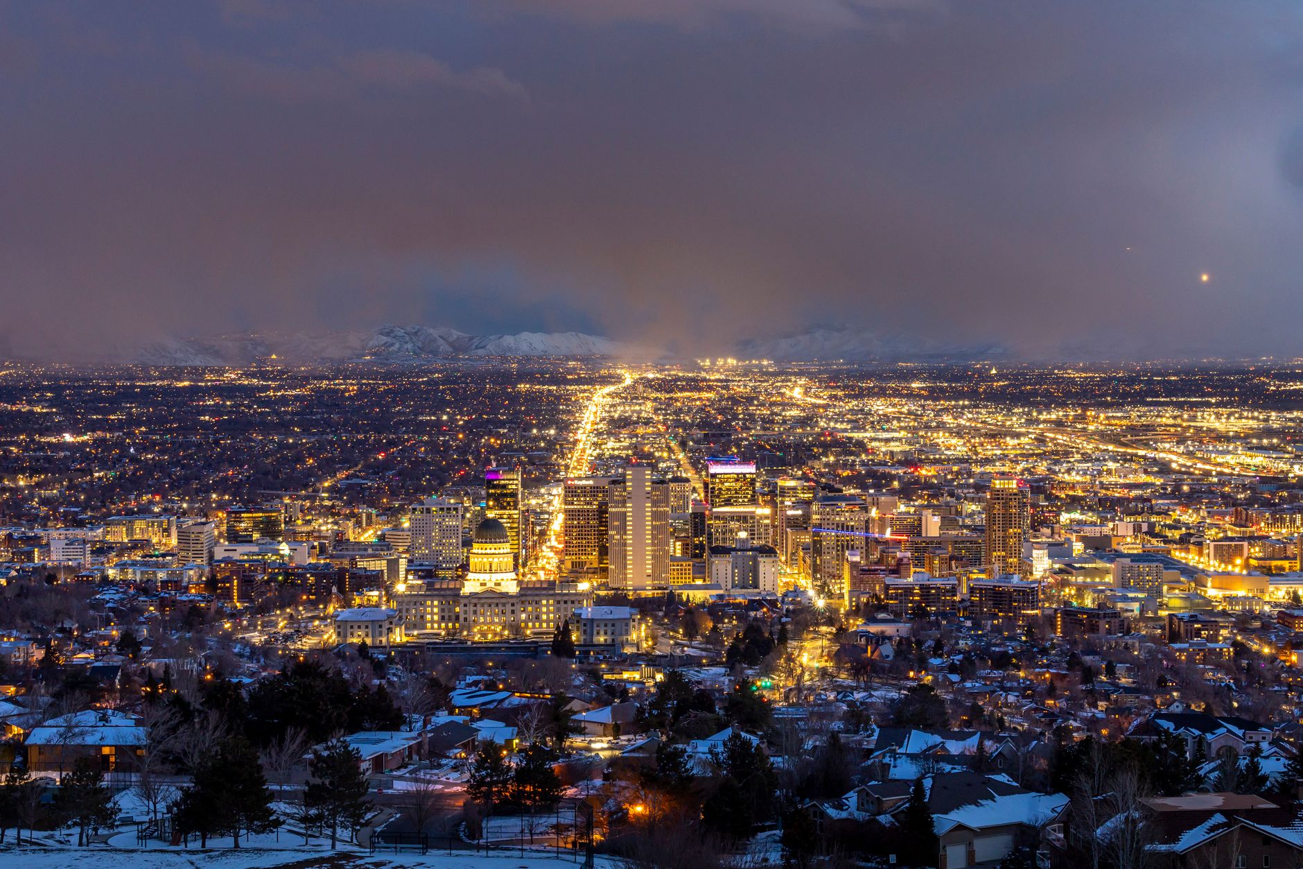 A breathtaking aerial view of Salt Lake City illuminated at night, showcasing its urban beauty.
