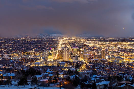 A breathtaking aerial view of Salt Lake City illuminated at night, showcasing its urban beauty.