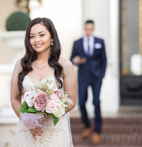 Portrait of Smiling Bride with Flowers Bouquet