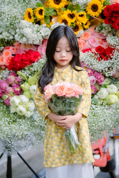 A Little Girl Holding a Bouquet 