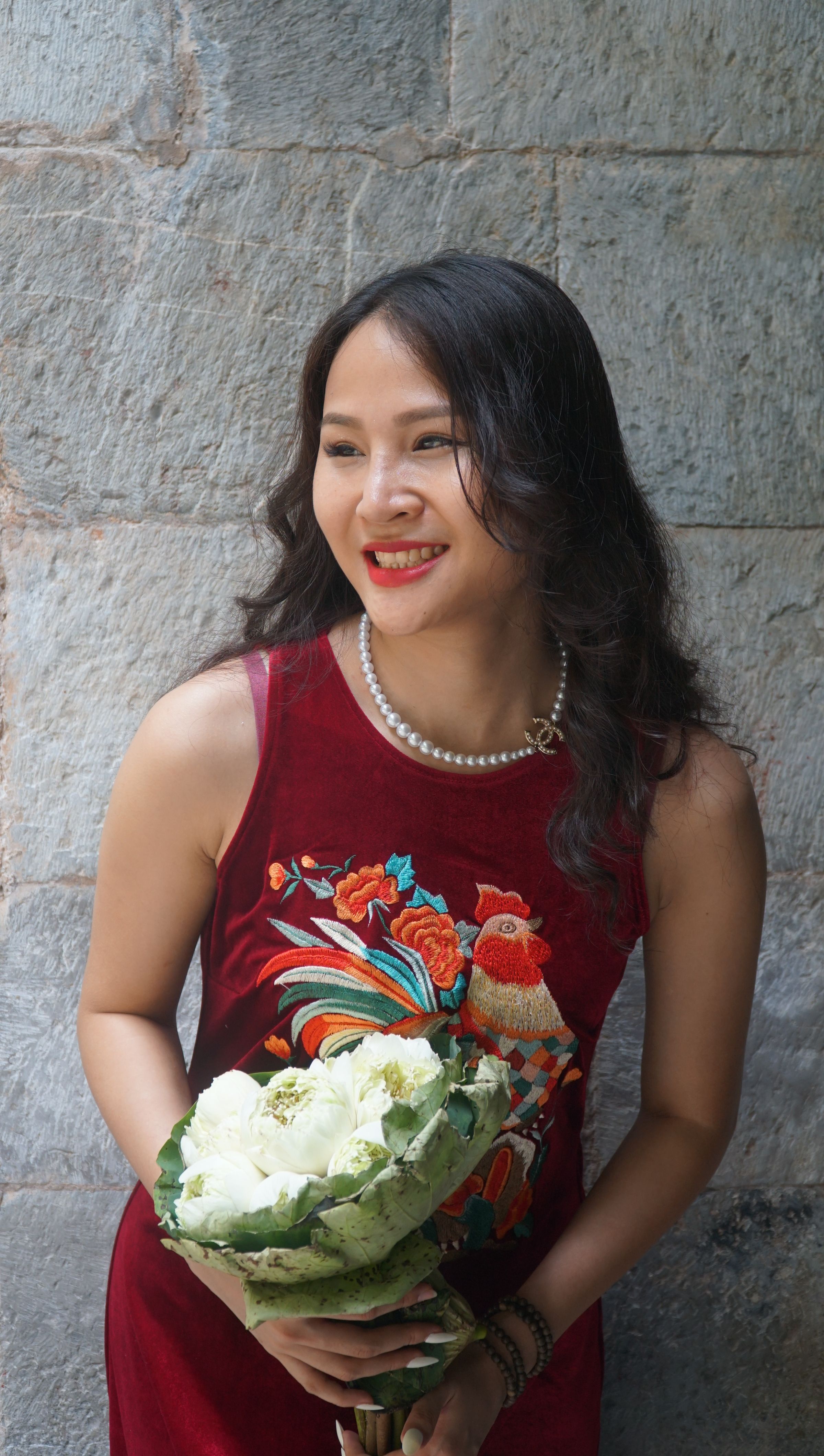 Smiling Woman in Red Dress Standing with Flowers · Free Stock Photo
