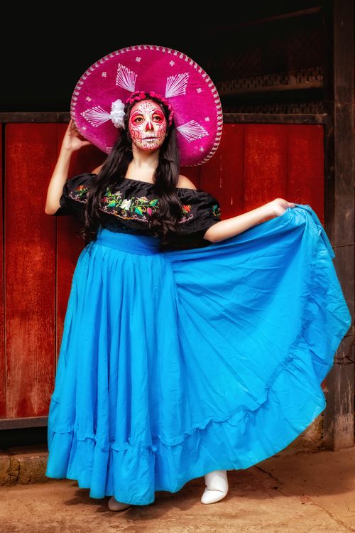Free Colorful portrayal of woman in Mexican traditional attire with face paint. Stock Photo