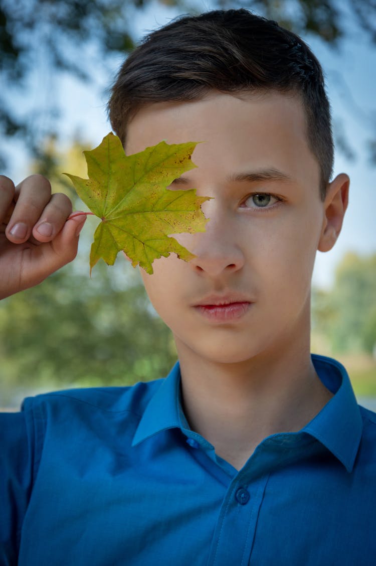 Portrait Of Boy With Leaf