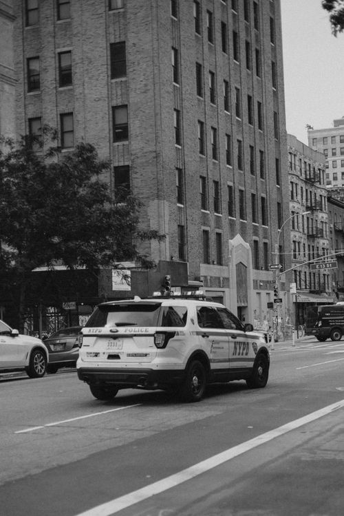 Free Monochrome shot of an NYPD police car on an urban street in New York City. Stock Photo