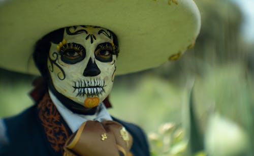 A man with a skull face painted on his face