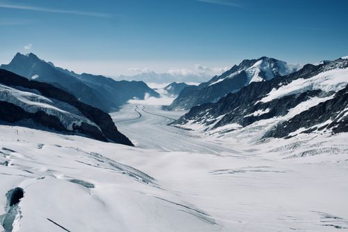 Free A breathtaking view of the glacial landscape in the Swiss Alps during winter with snow-covered peaks. Stock Photo