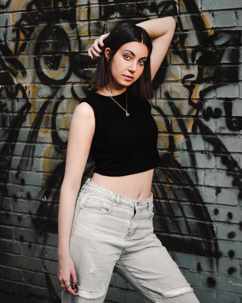 Portrait of Woman Standing by Wall with Graffiti