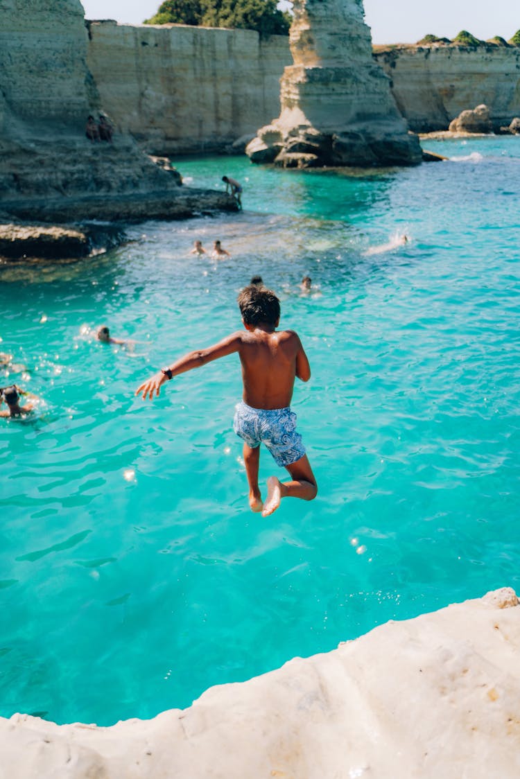 Boy Jumping Into Water