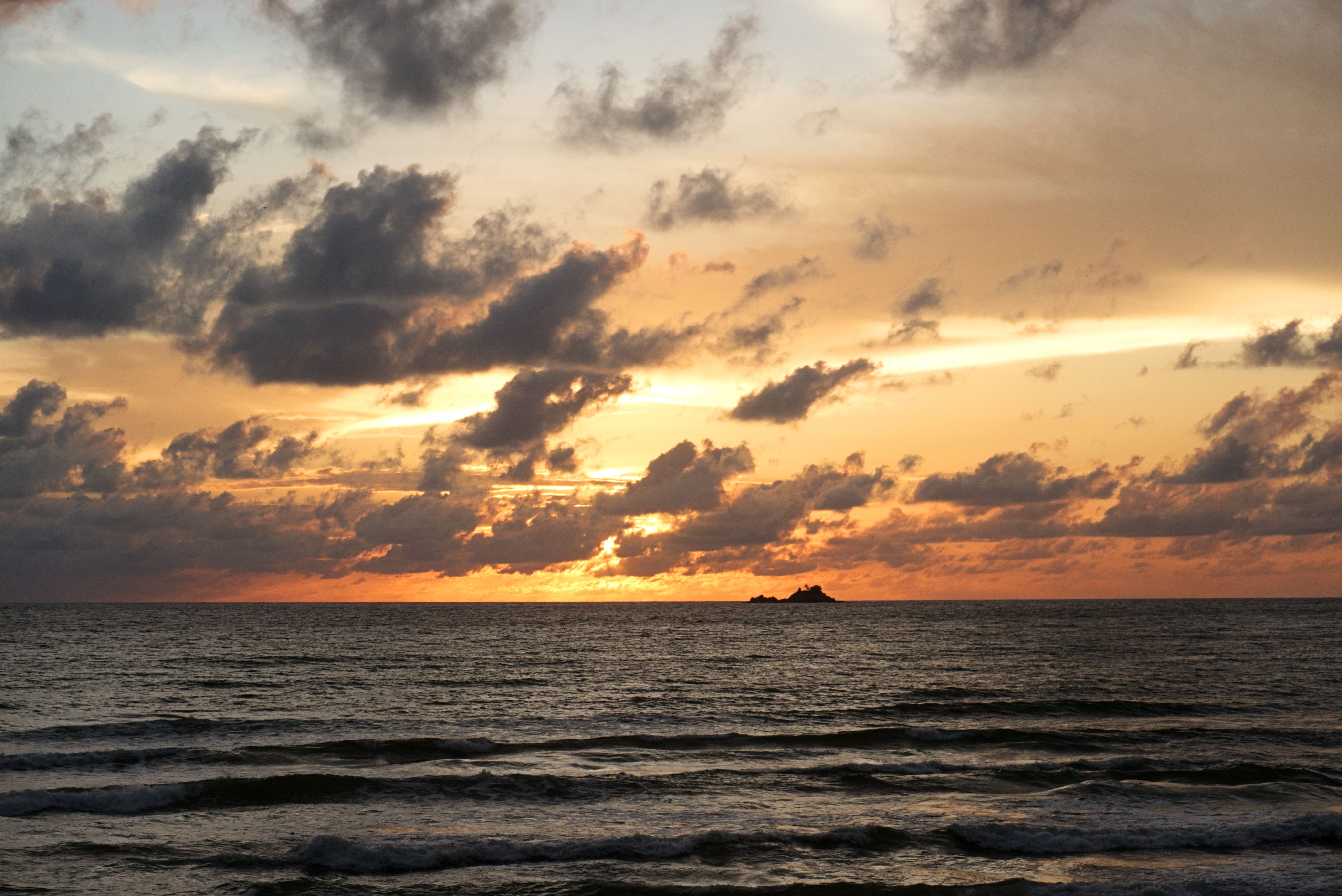 Rain Clouds over Sea Shore at Sunset · Free Stock Photo