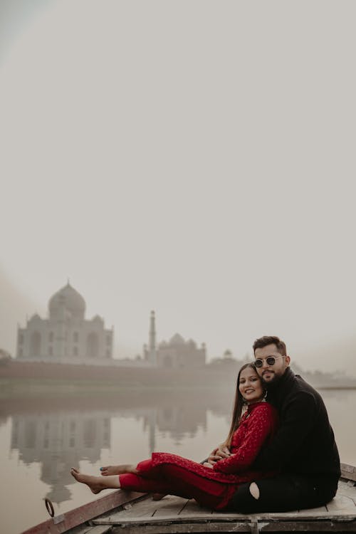 Couple on a Boat with a View of the Taj Mahal, India 