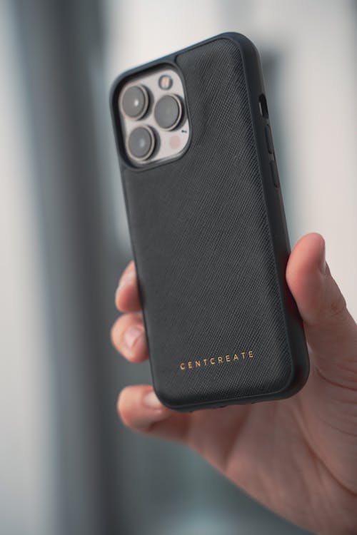 Free Close-up of a Person Holding an iPhone in a Black Case Stock Photo