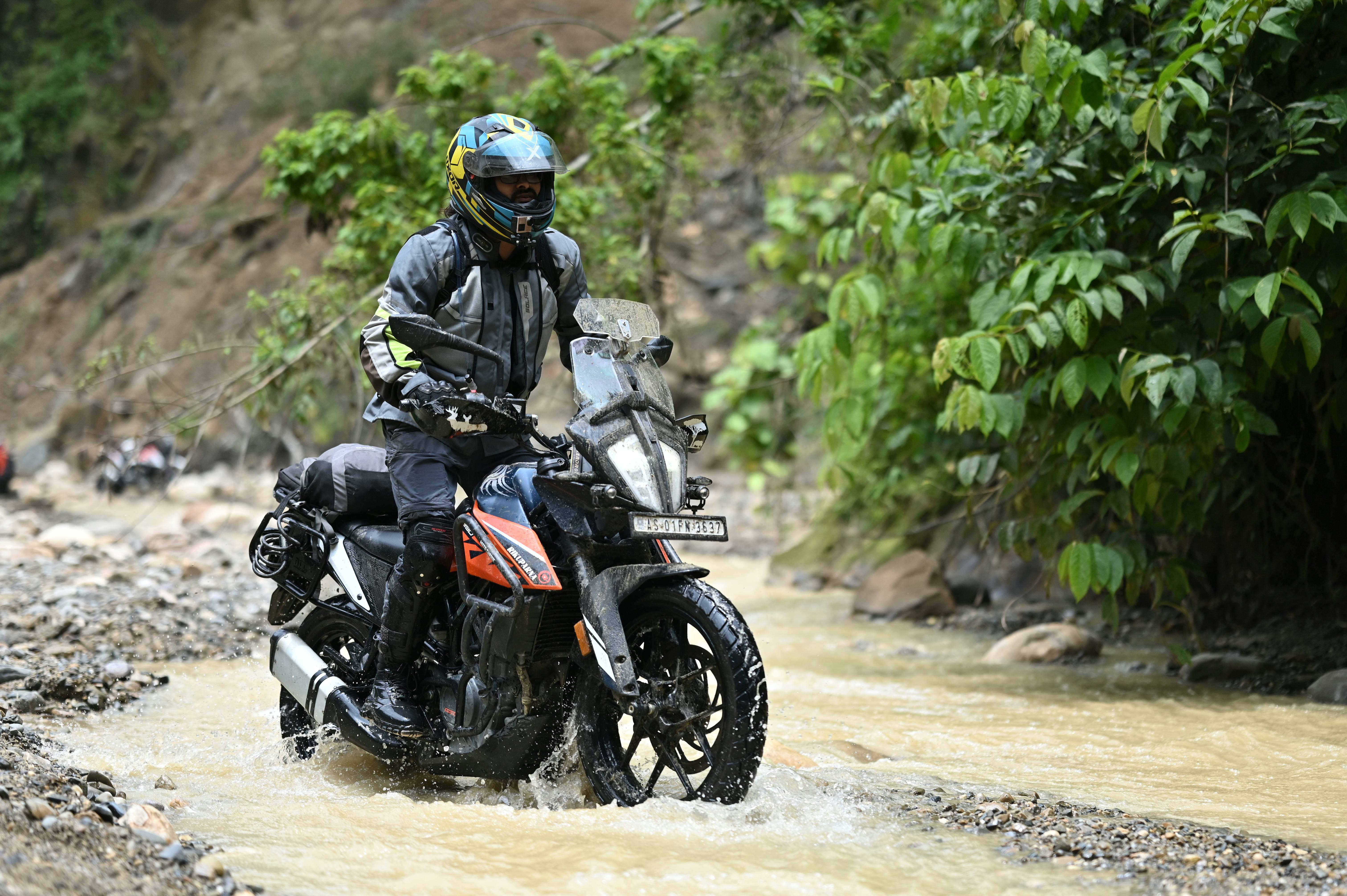Rider exploring rugged terrain in Guwahati, India, showcasing off-road motorcycling adventure.
