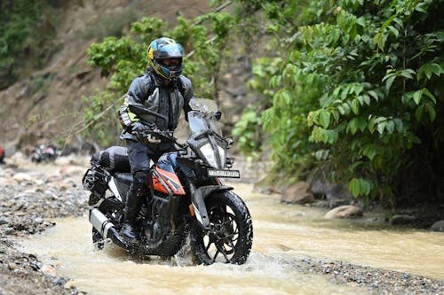 Man Riding a Motorcycle in Mud 