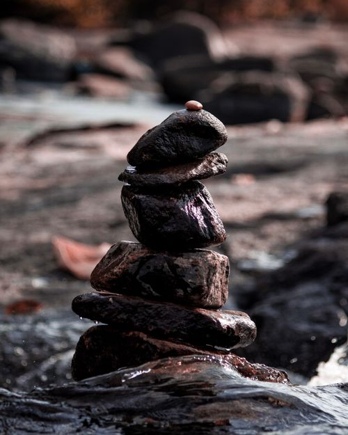 Free A serene stack of wet stones in nature symbolizing balance and harmony. Stock Photo