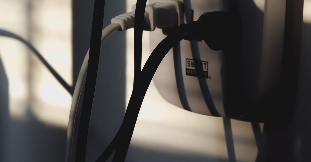 Plugs Plugged into Wall Outlet · Free Stock Photo