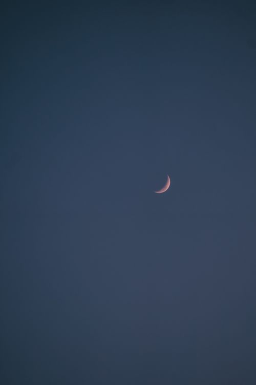 Free Beautiful crescent moon in a dark sky with ample copy space, captured in Jakarta. Stock Photo