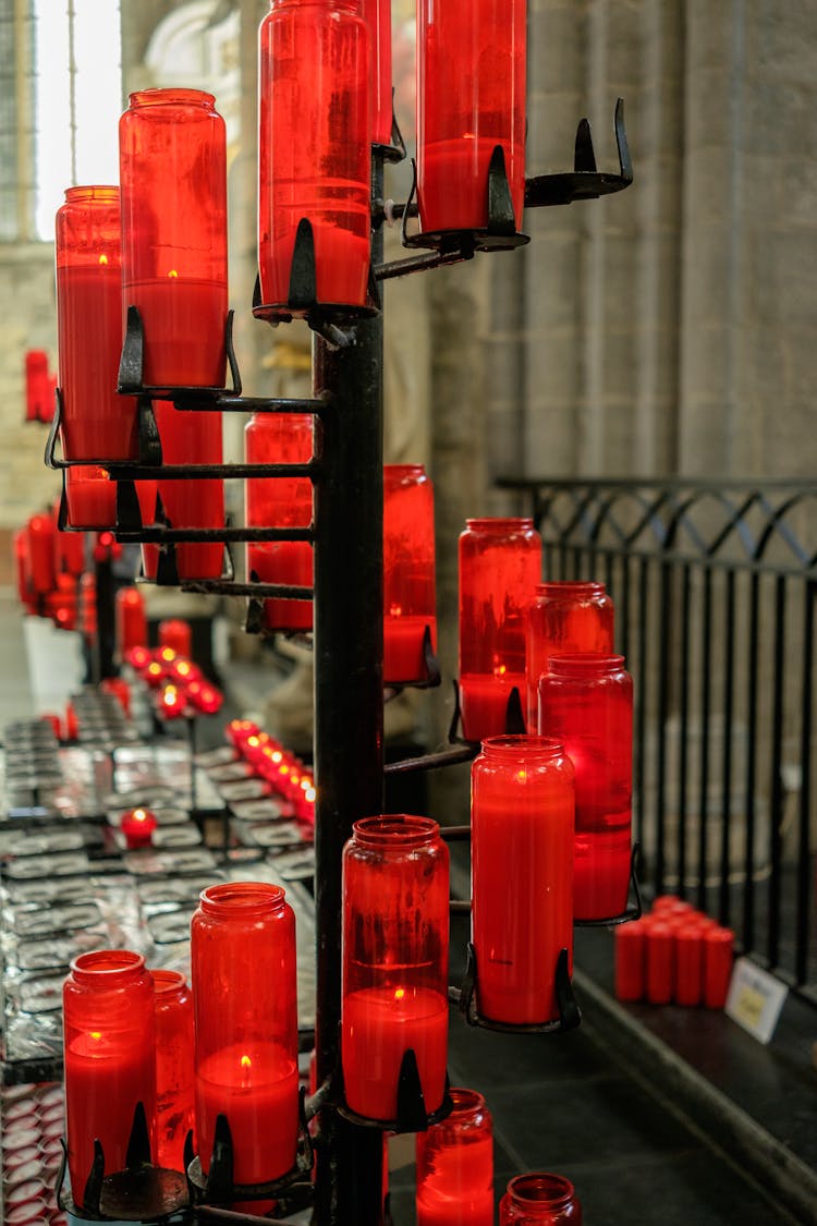 Close-up Of Red Candles Standing In Front Of A Church 