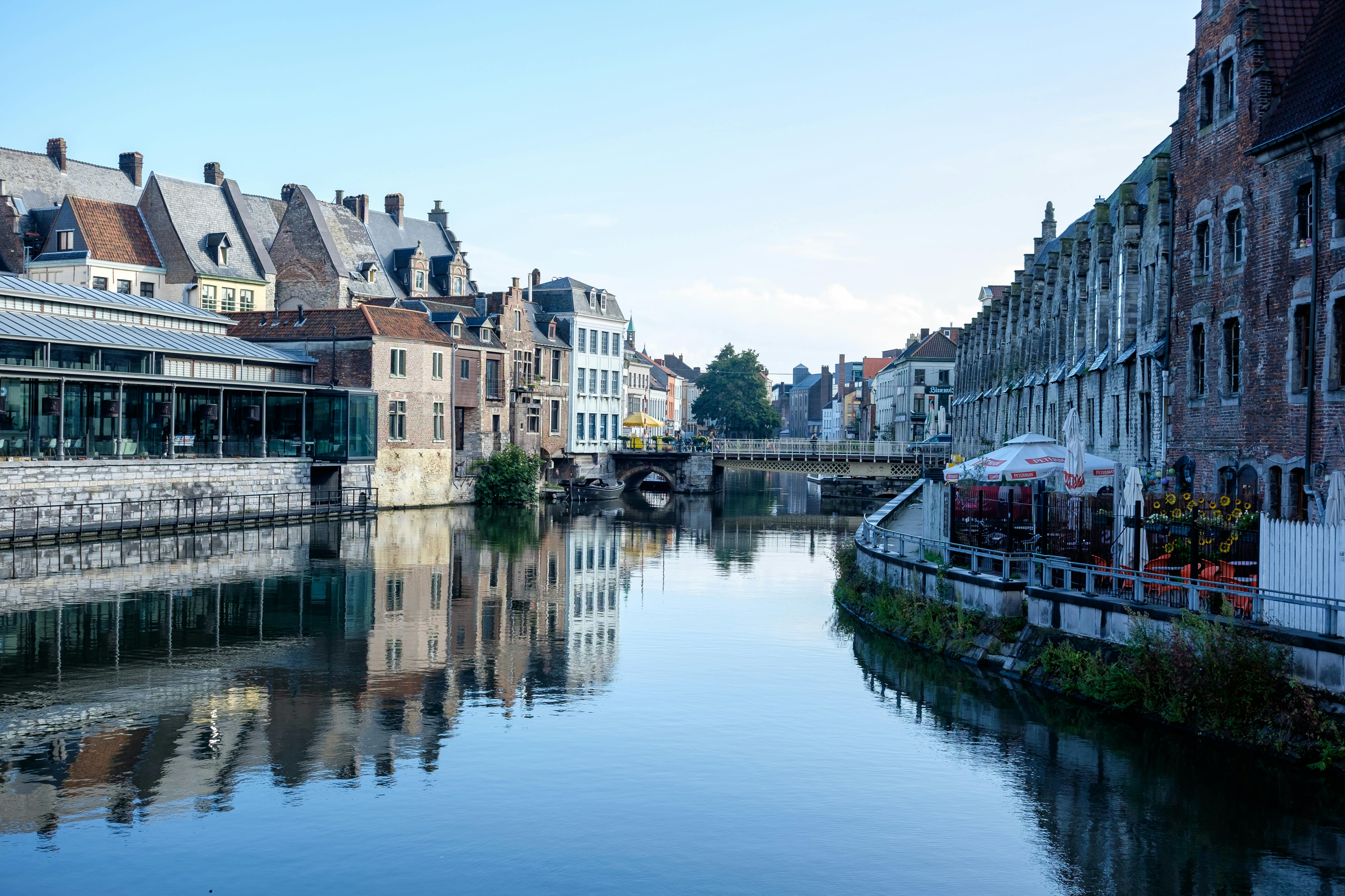 Picturesque canal scene in Ghent, Belgium, showcasing historic architecture and tranquil reflections. - Gante