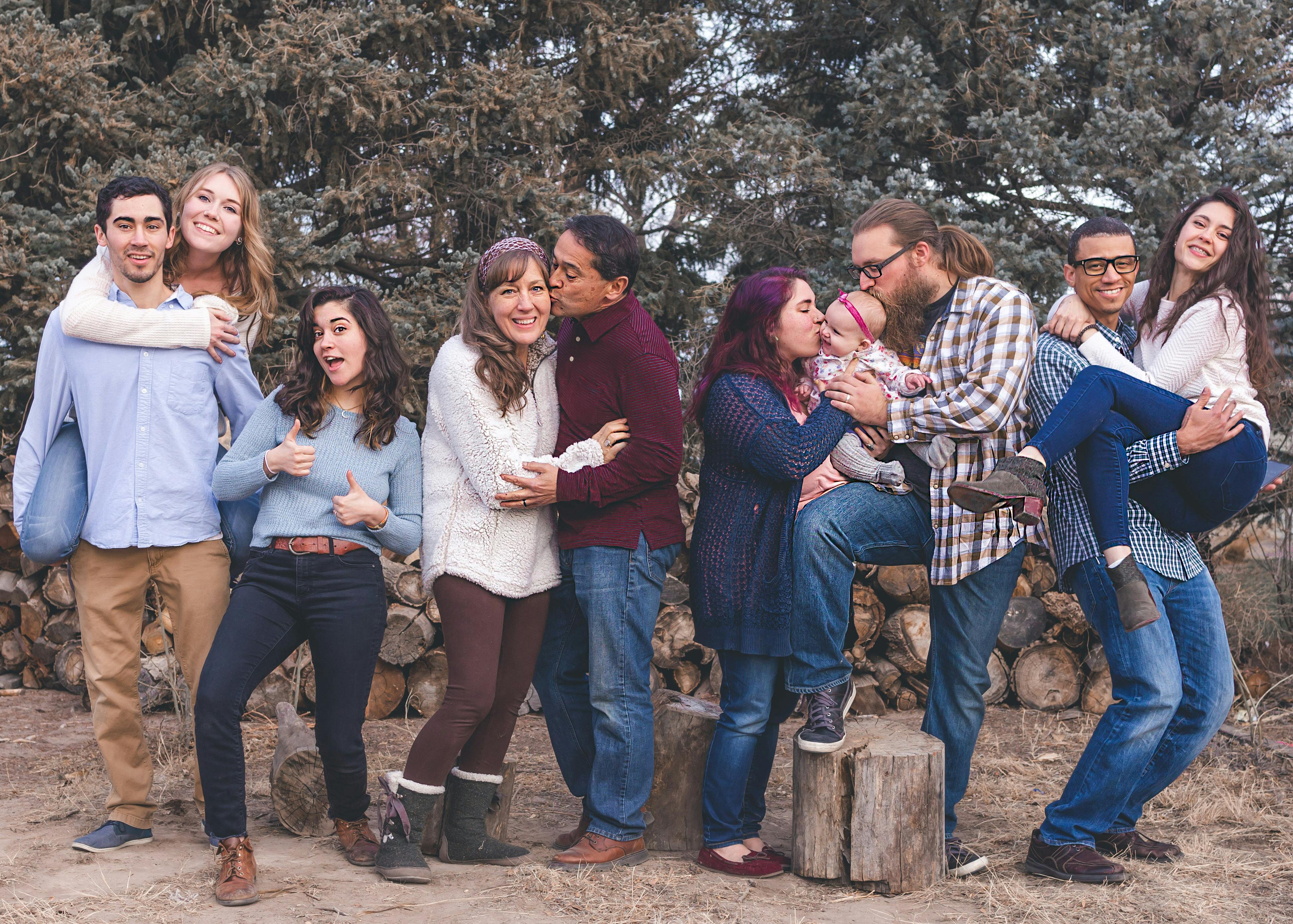 people standing in front of wood pile