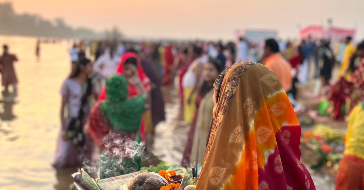 Women in Traditional Saree Bringing Ritual Offerings to River at Sunrise · Free Stock Photo