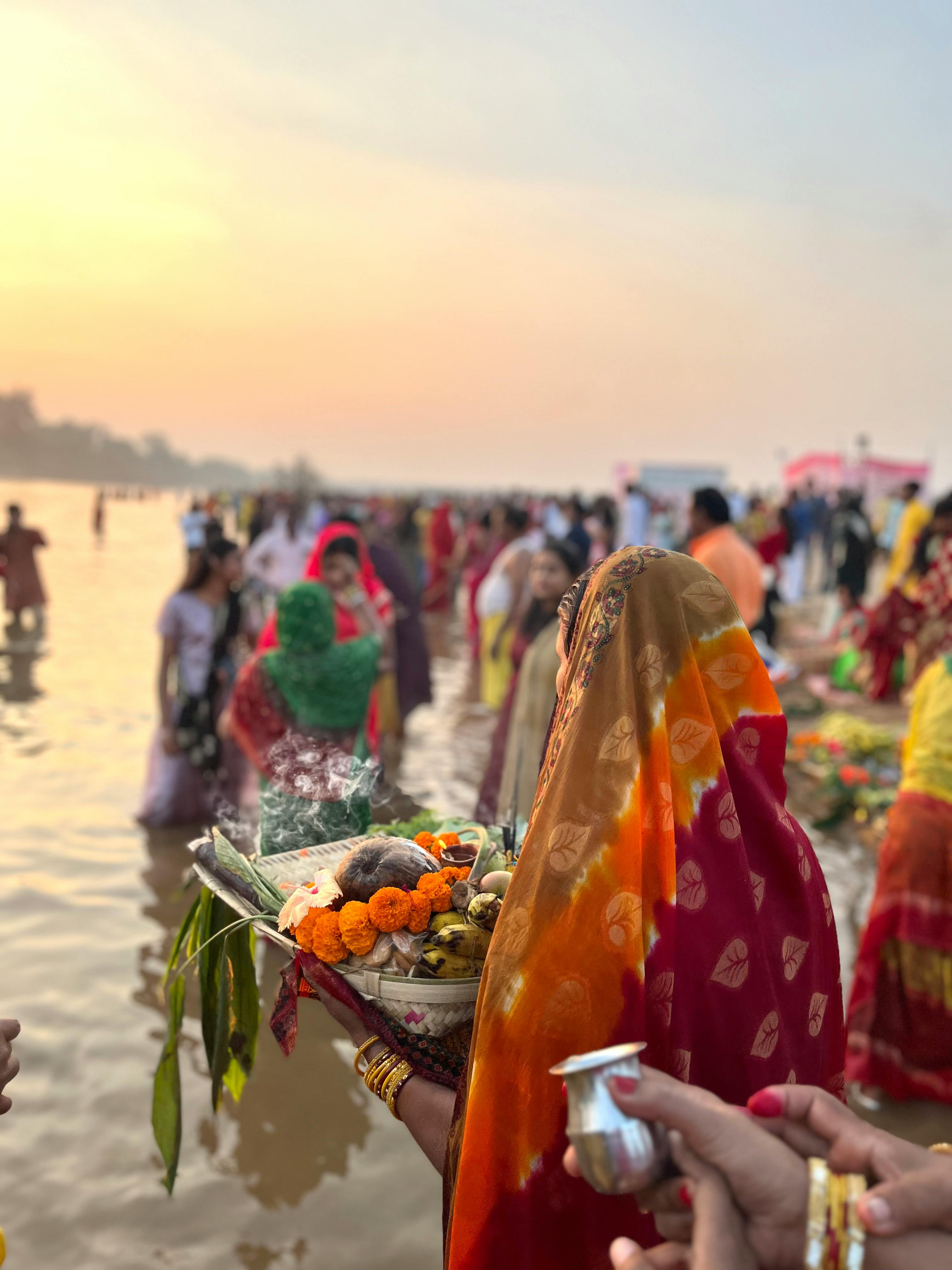 Women in Traditional Saree Bringing Ritual Offerings to River at Sunrise ·  Free Stock Photo