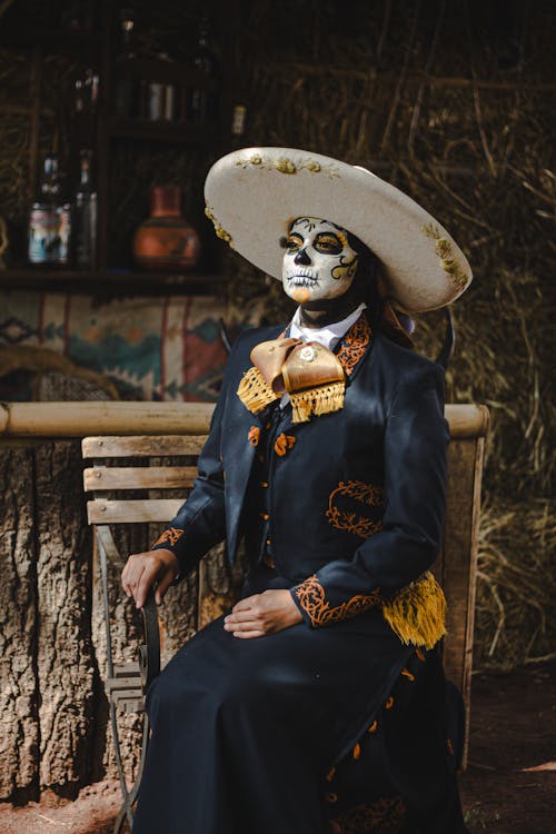 Woman Sitting in Sombrero and Costume for Dia de Muertos