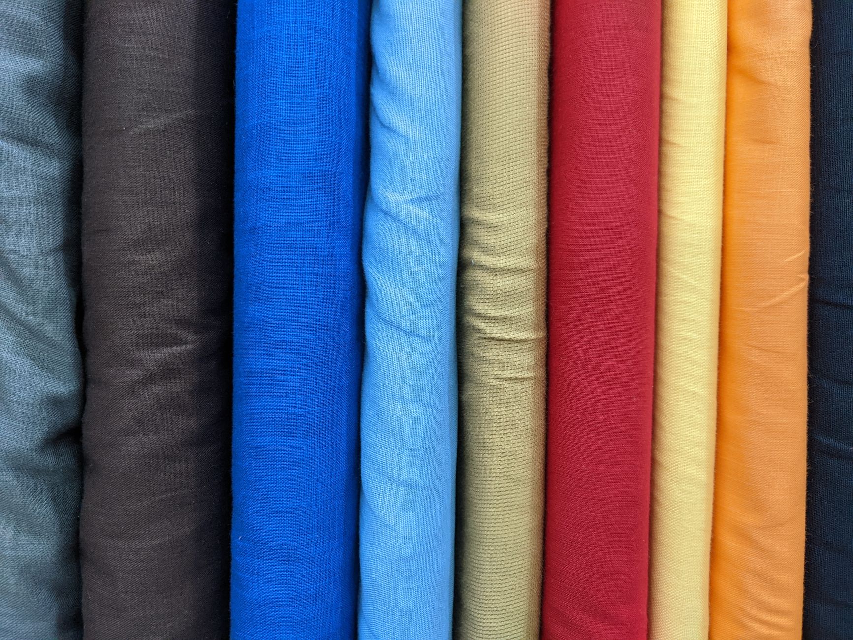 Three linen fabric swatches showing lightweight, midweight, and heavyweight GSM side by side