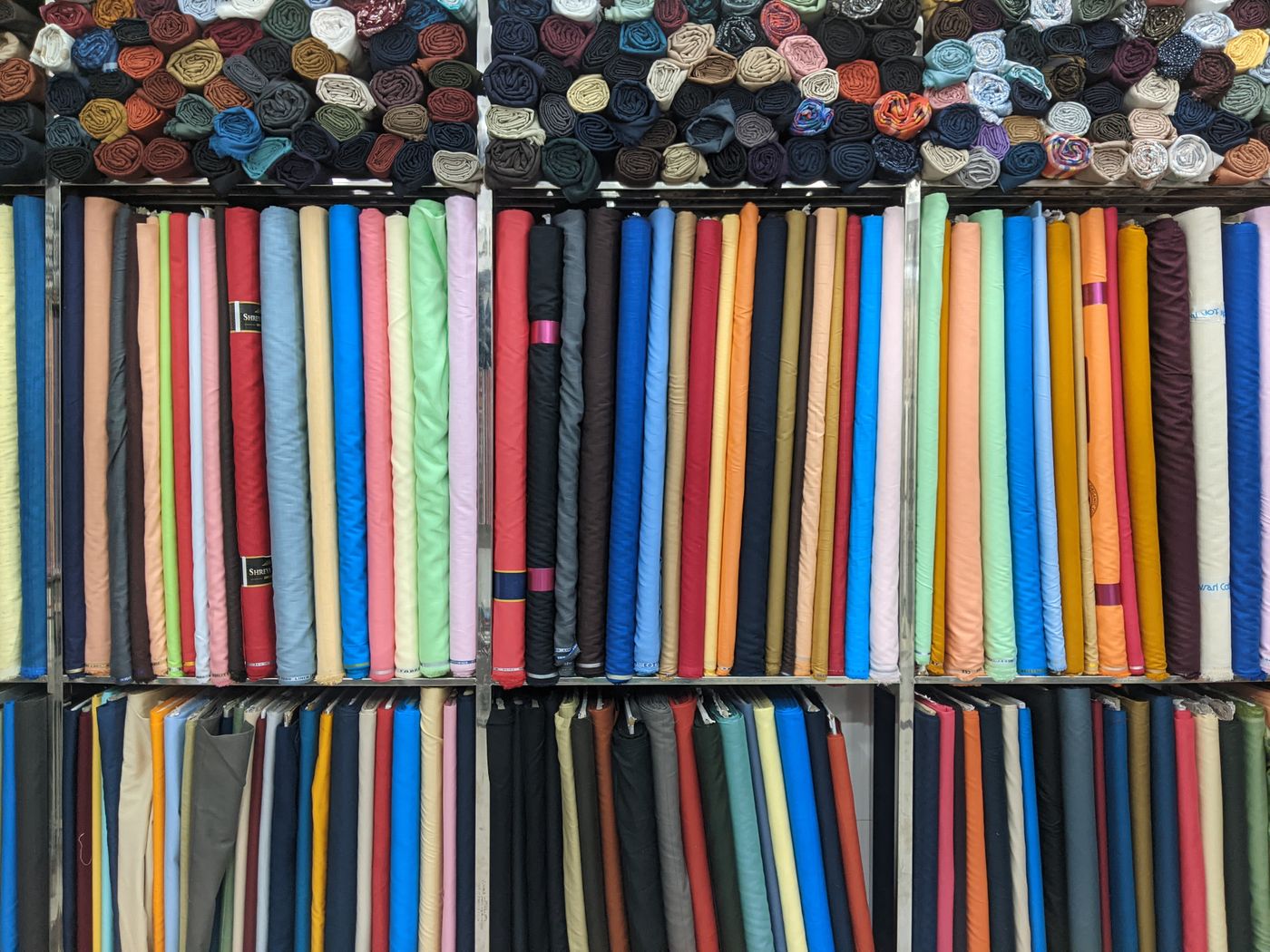 Rolls of silk and lining fabric on the atelier shelves