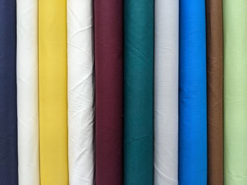 Free A vivid and diverse collection of colorful fabric rolls stacked in a row. Stock Photo