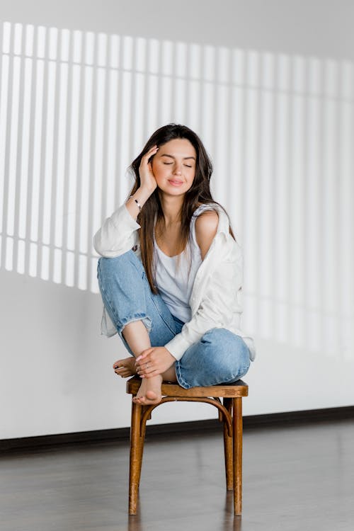 Free Smiling Woman is Sitting on Chair Stock Photo