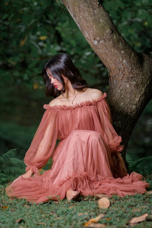 Woman in Dress Sitting and Posing