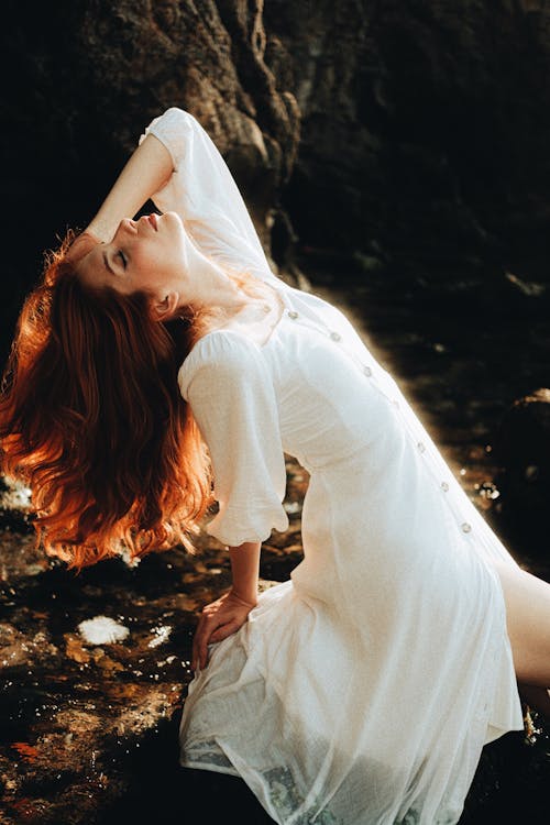 Woman in White Dress Posing with Eyes Closed