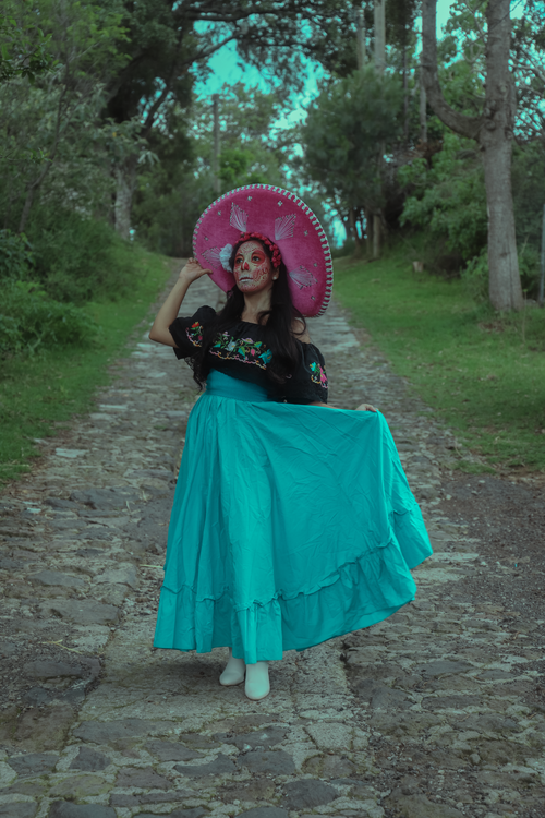 Free A young woman in a vibrant Catrina costume celebrates Día de Muertos outdoors. Stock Photo