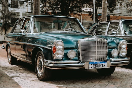 Classic Mercedes limousine with a vintage charm, parked on an urban street.