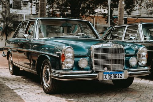 Free Classic Mercedes limousine with a vintage charm, parked on an urban street. Stock Photo