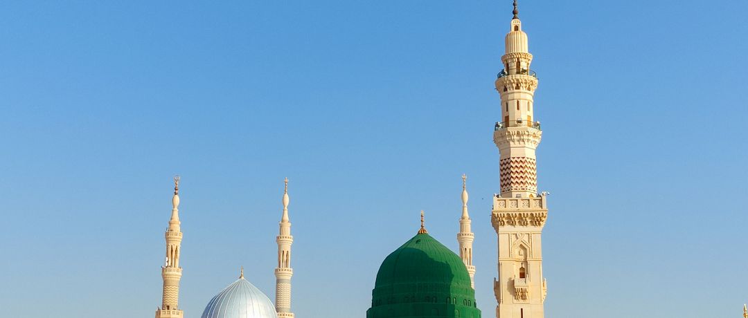 Scenic view of the Prophet's Mosque in Medina, showcasing its iconic minarets and dome under a clear blue sky., Madinah, Saudi Arabia, stay connected here with a travel eSIM