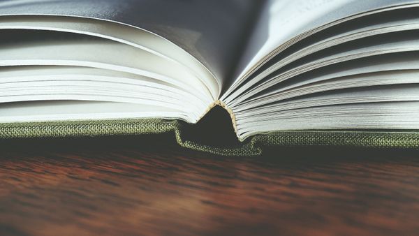 Open hardcover book showing pages and binding — Suzy Hazelwood on Pexels