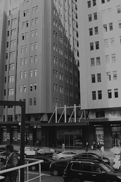 Black and White Photo of a Street and Apartment Blocks in a City 