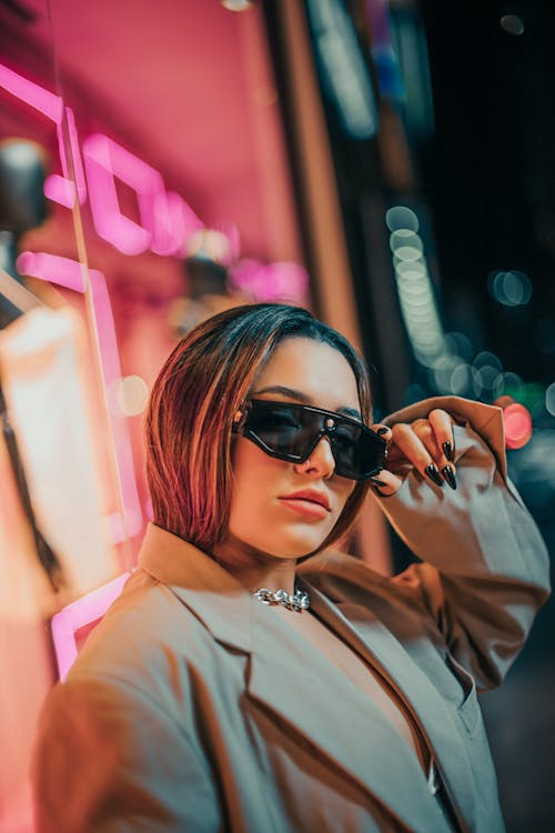 Woman in Brown Jacket Fixing Shades