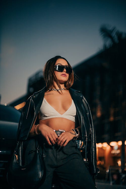 Young Fashionable Woman Posing in City at Dusk