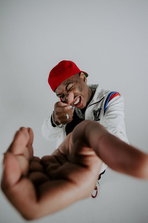 Wide Angle Studio Shot of a Young Man Wearing a Cap Backwards 