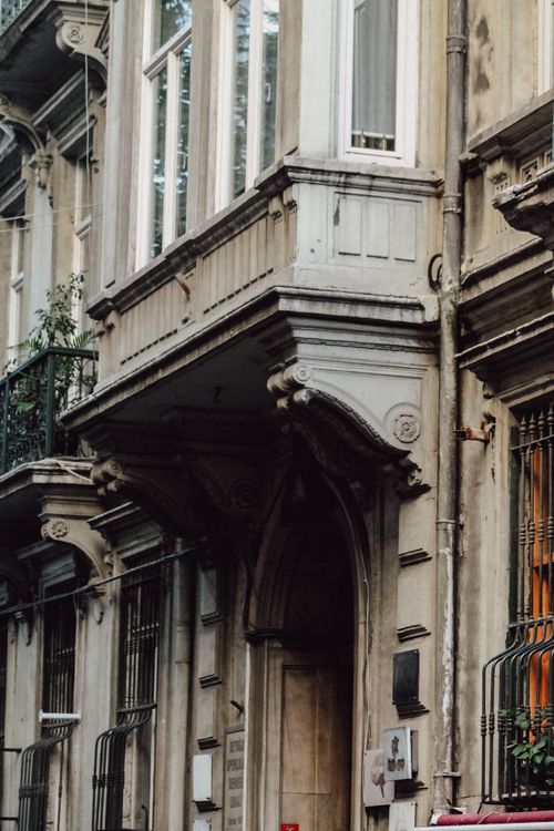 Free Detailed view of a historic urban residential facade with ornate architectural elements. Stock Photo