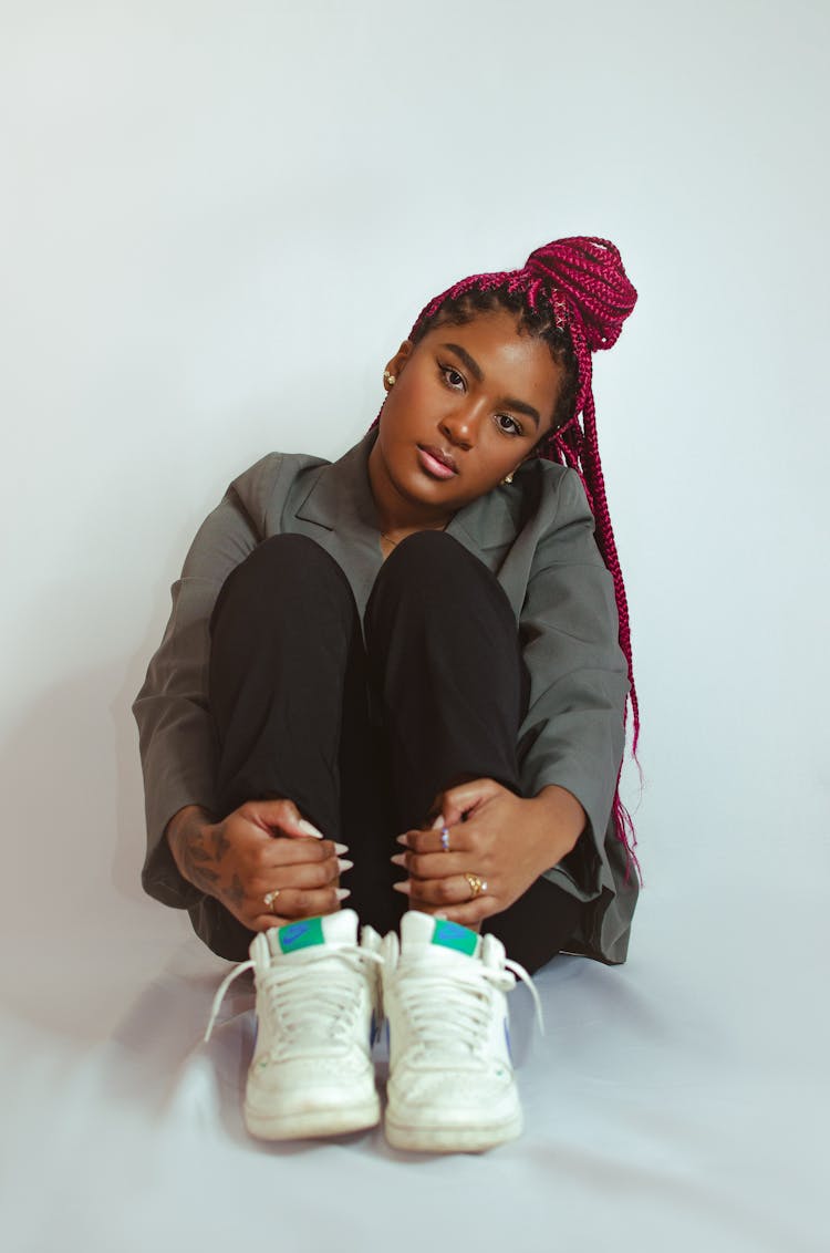 Cute Young Woman Sitting In The Studio