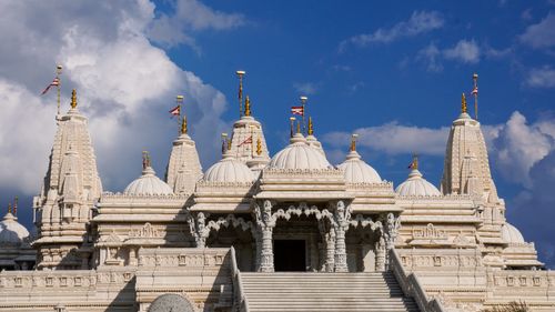 Free Majestic view of BAPS Shri Swaminarayan Mandir under a clear blue sky, highlighting its intricate architecture. Stock Photo
