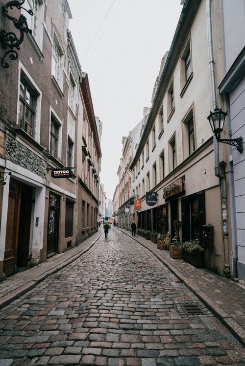 Free Explore the historic cobblestone streets of Riga's Old Town, showcasing classic European architecture. Stock Photo