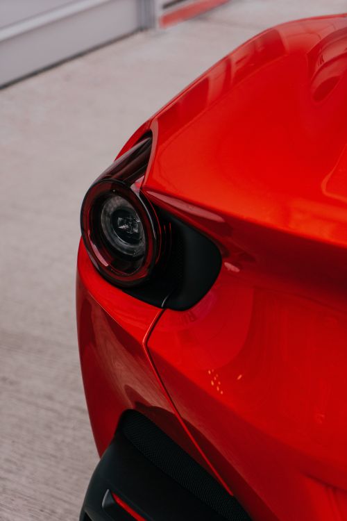 Free Detailed shot of a red sports car taillight showcasing sleek design. Stock Photo